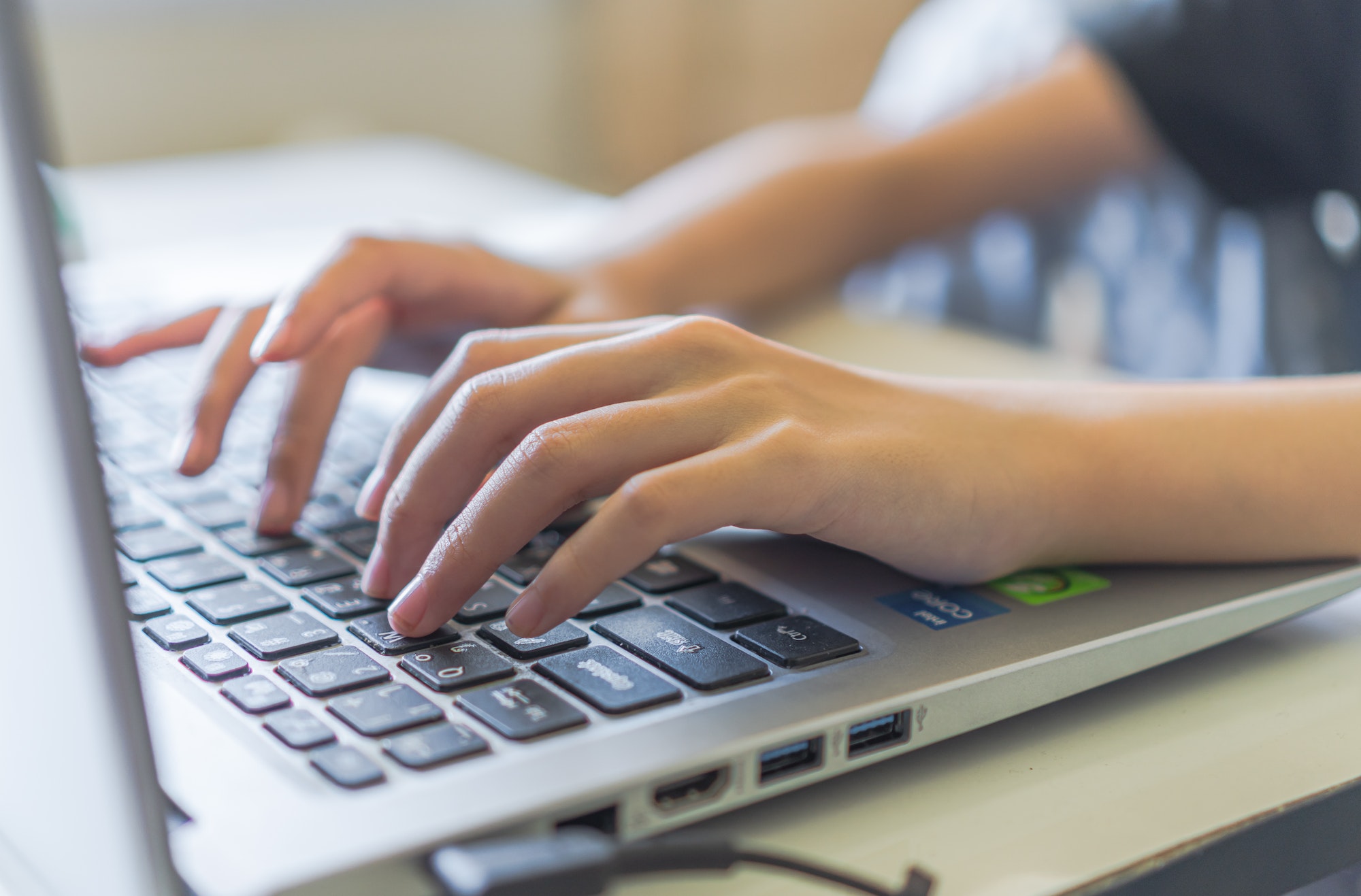 Girl hand typing on keyboard laptop